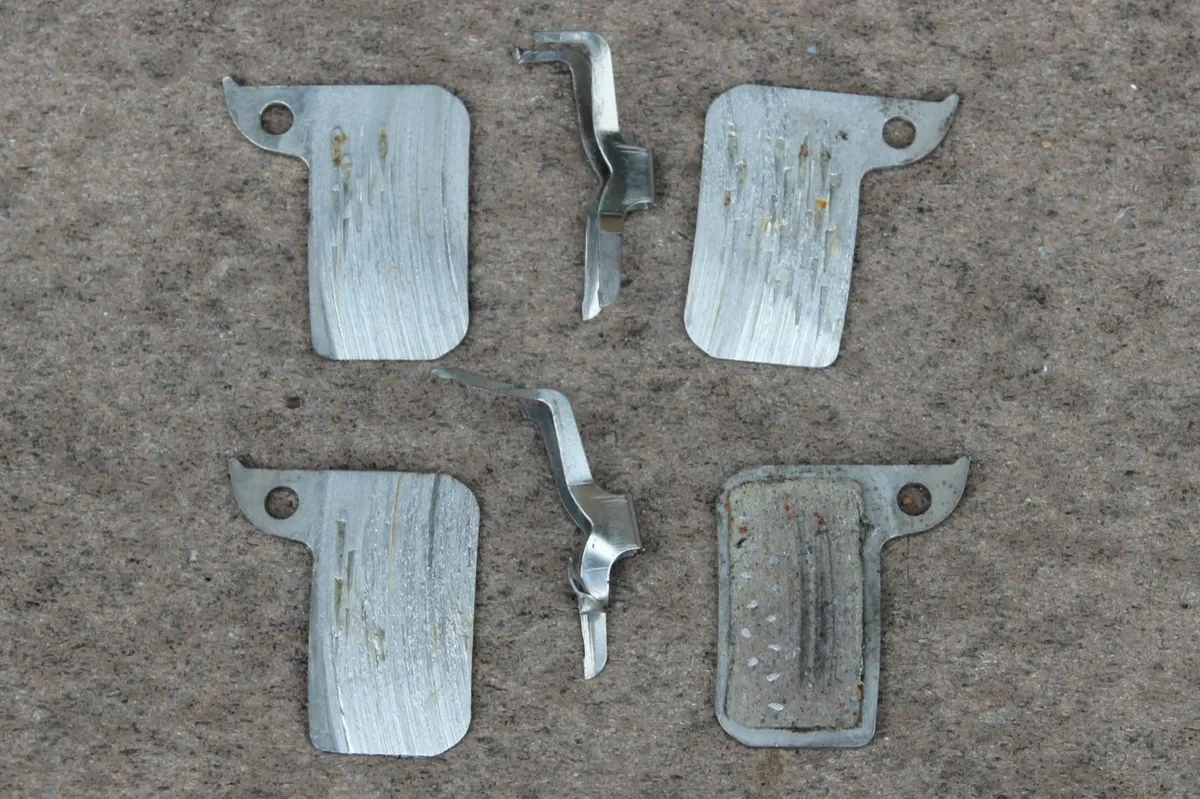 The pads were completely worn off on three backing plates. And even the surface of the backing plates and parts of the springs were ground off