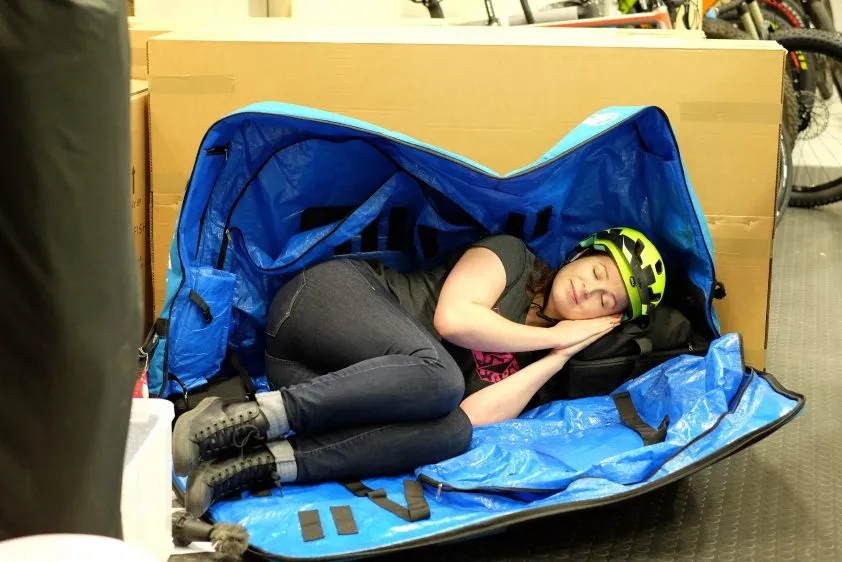 Woman sleeping in a bike bag.