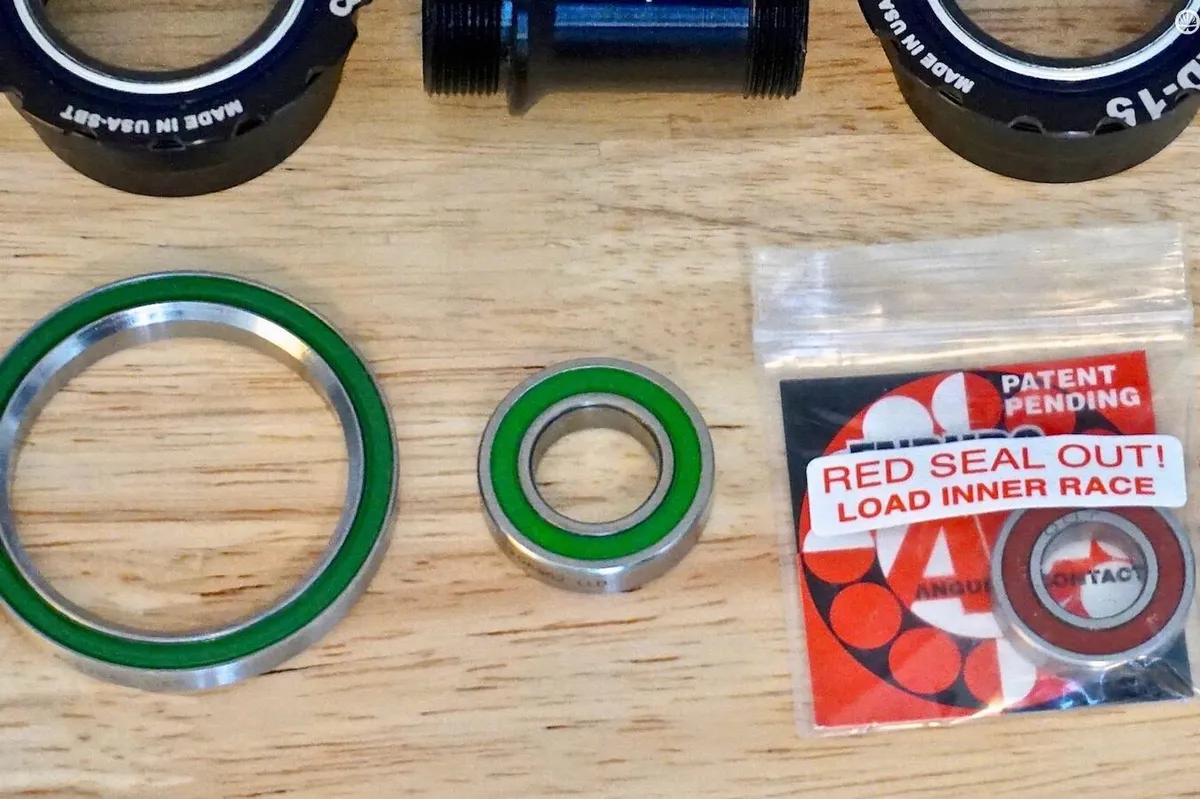 A few examples of cartridge bearing systems — an angled headset on the left and a tiny front hub bearing in the middle and on the right