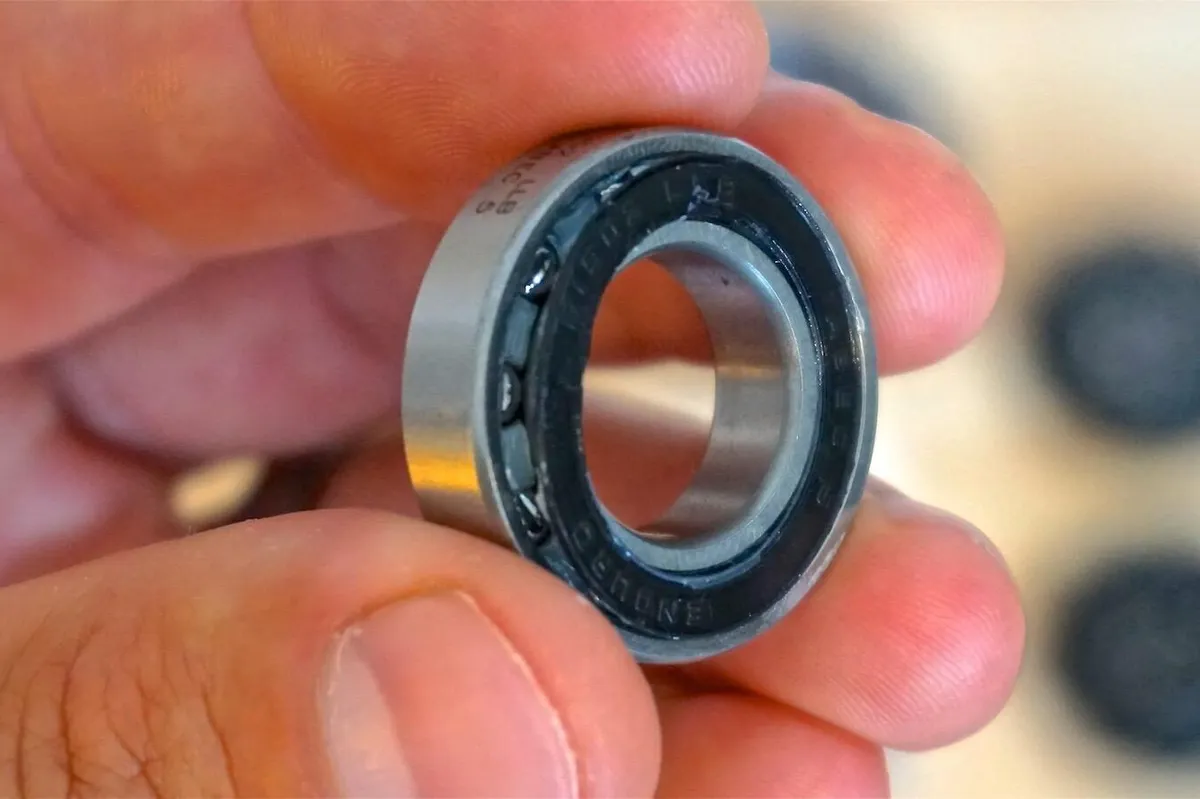 Seals on cartridge bearings can be carefully removed to clean and inject fresh grease, but be warned, this can lead to a ruined bearing if done incorrectly