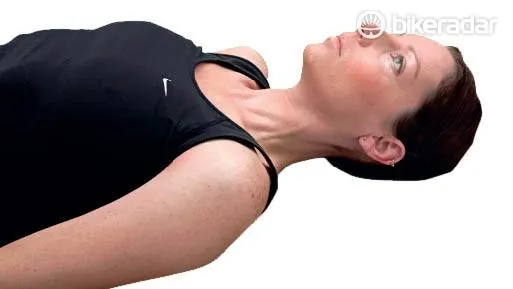 Sore neck? First, lie down flat on the floor with your knees bent