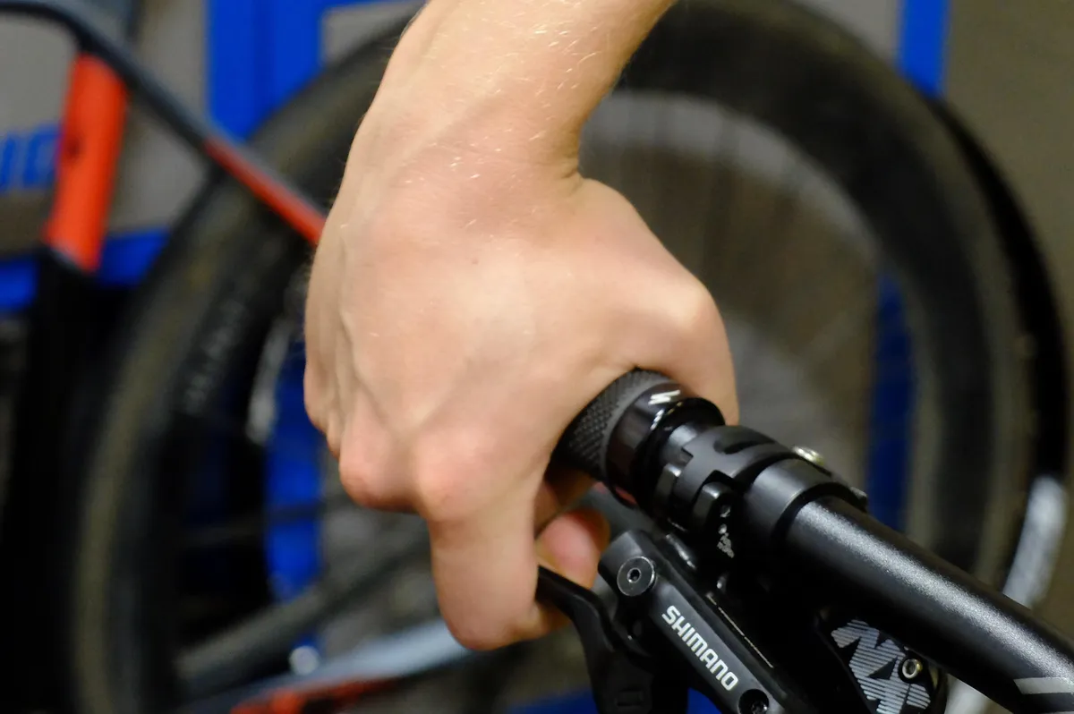 Pointing your brake levers too far down rolls your wrist over the top of the bars