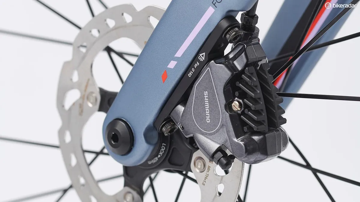 Close-up detail of hydraulic disc brakes at the wheel hubs