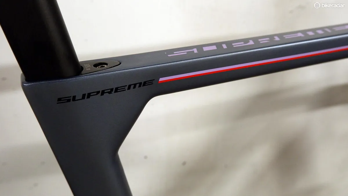 Detail photograph of the name of the bike, Fuji Supreme, printed on the top tube of the bike frame