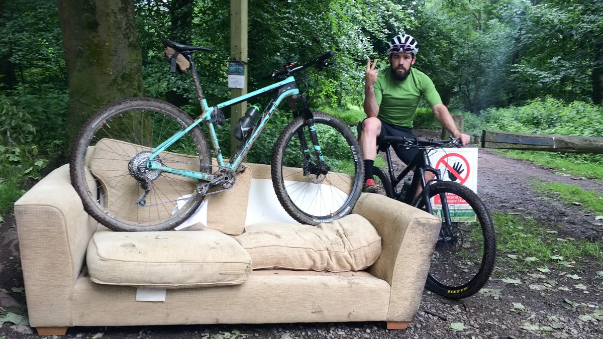 hardtail mountain bike and male cyclist on couch
