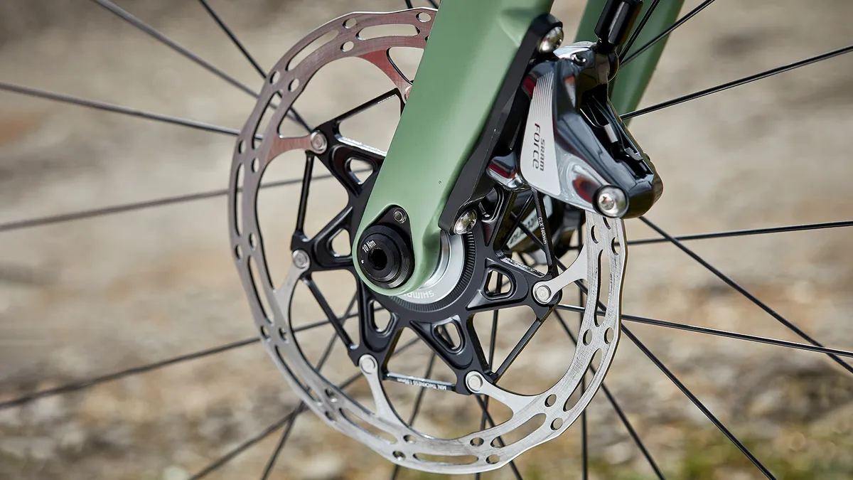 Hydraulic brakes and rotor on green road bike