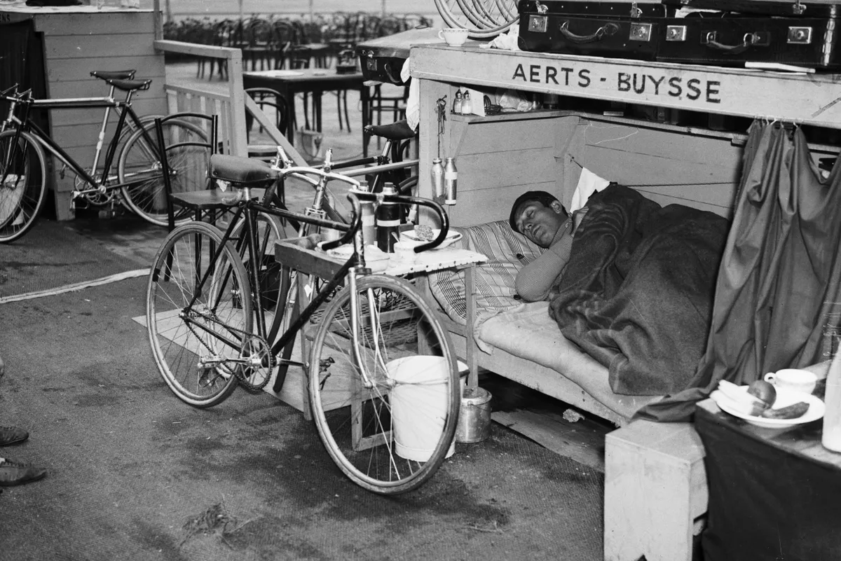 25th September 1936: Belgian cyclist Jean Aerts naps after he broke the record for the Mile during a six day cycling event at Wembley, London. (Photo by Derek Berwin/Fox Photos/Getty Images)