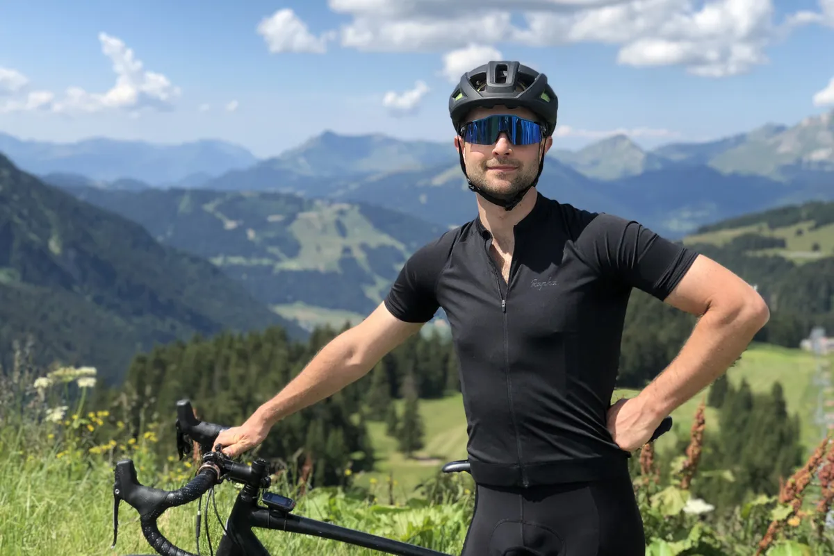 Alex Evans sits above Morzine in the French Alps in Summer on a road bike