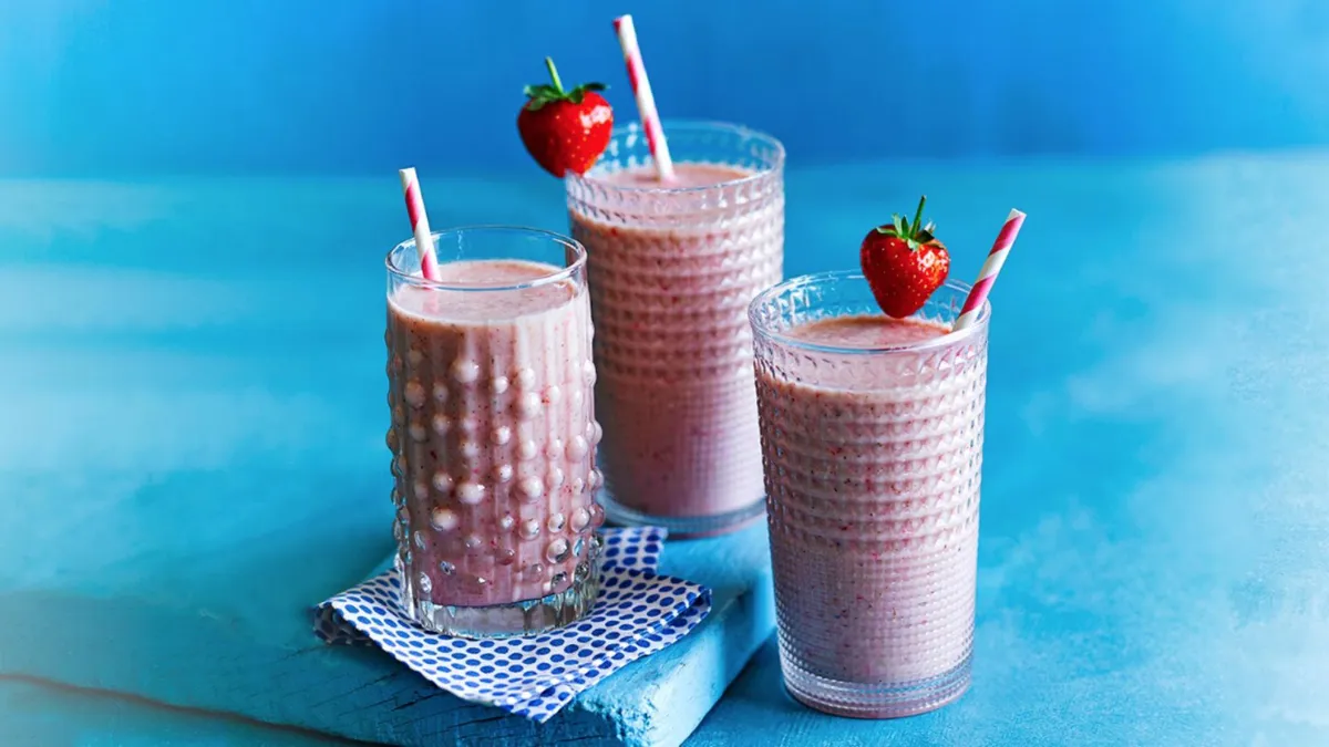 three pink smoothies with straws