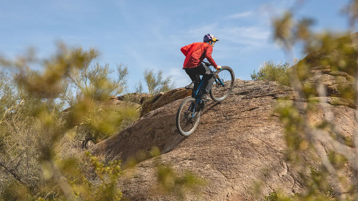 Aaron Chase rides Pivot electric mountain bike up a steep hill