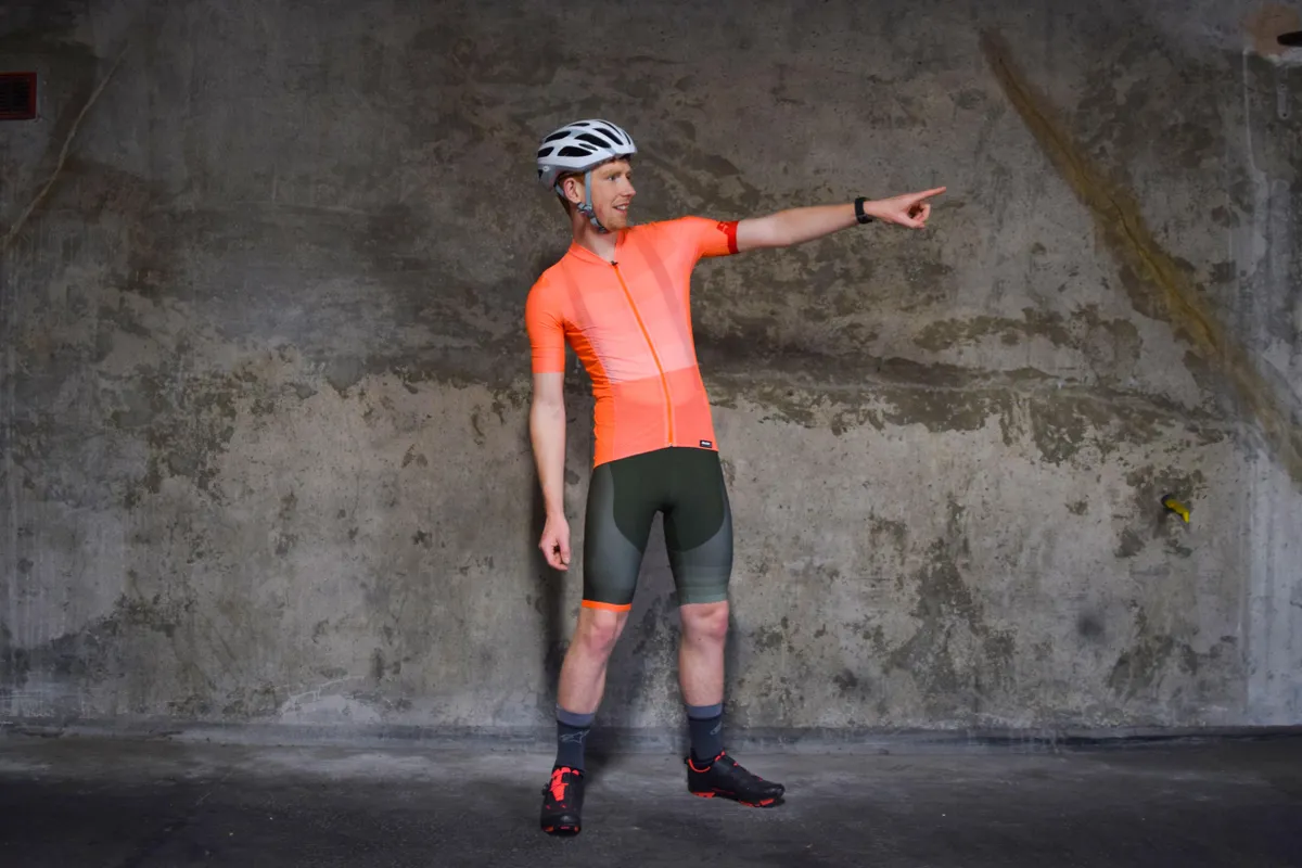 Santini orange-coloured cycling jersey and green shorts worn by a man