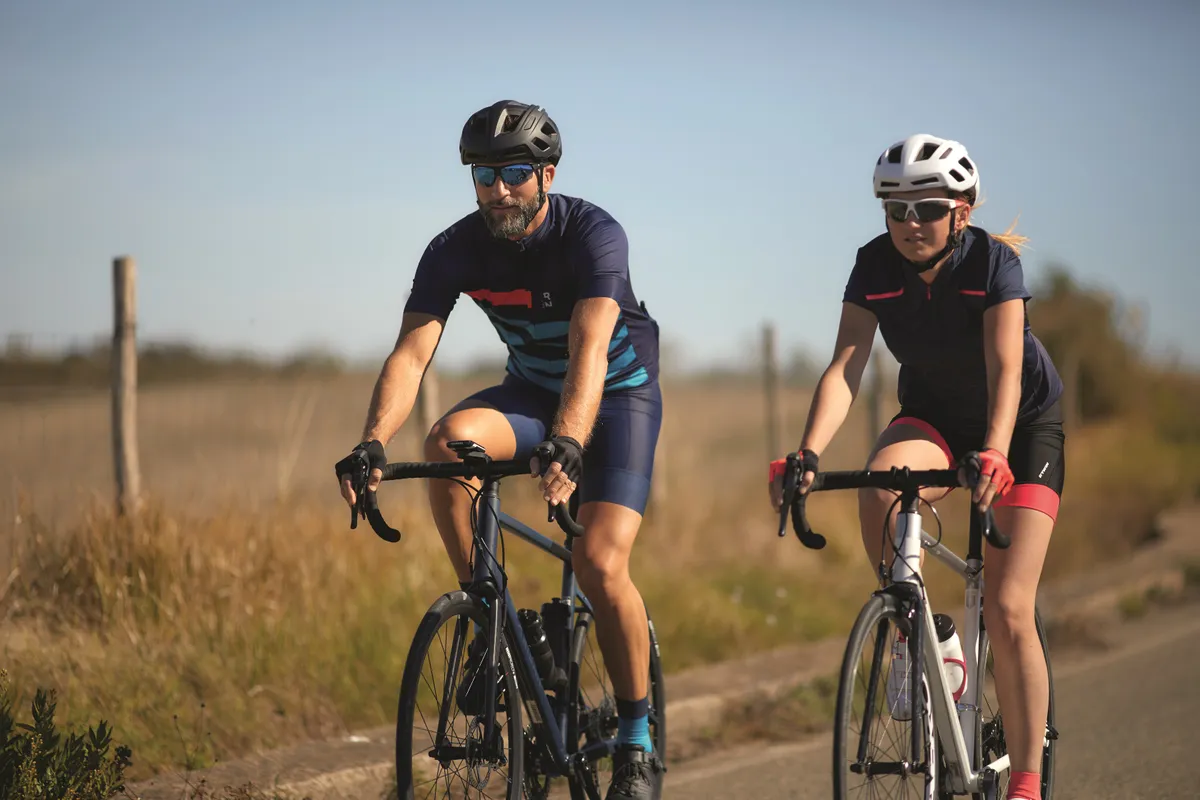 Two cyclists riding road bikes