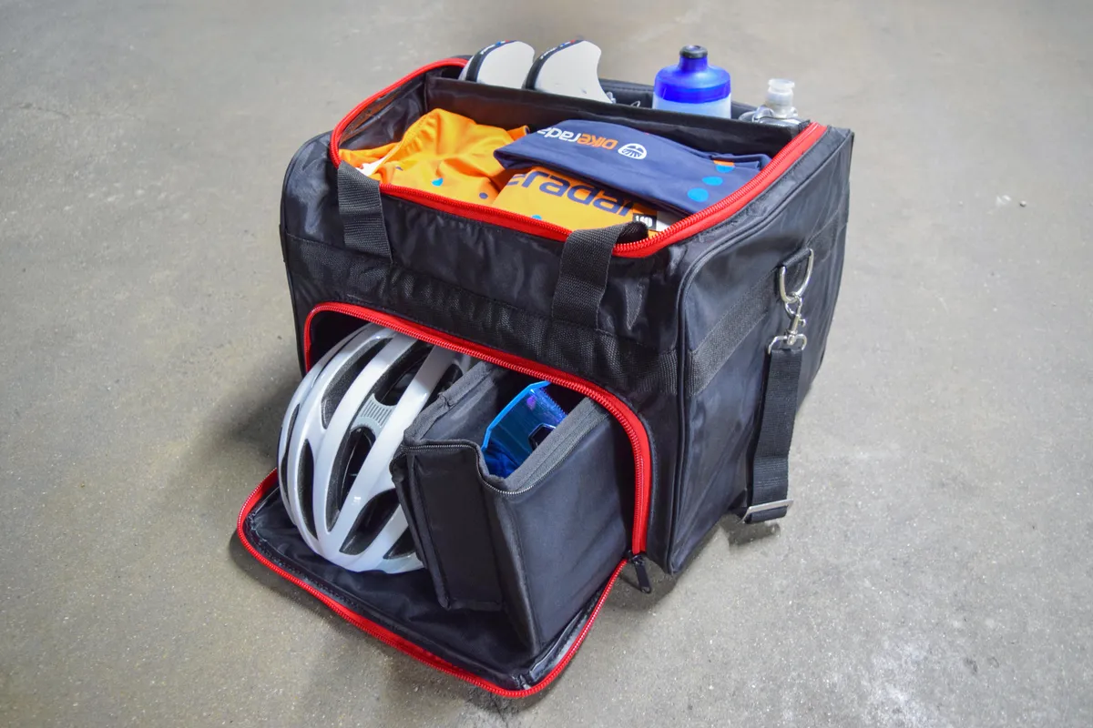 A Black Line Sprinting bag for cycling kit including a helmet, shoes, clothes, water bottles and glasses with individual compartments