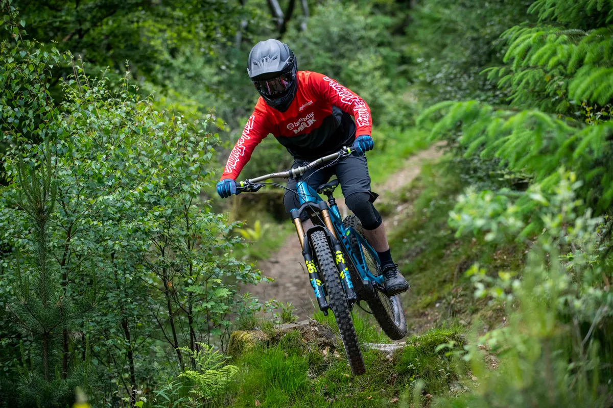 Man rides and an electric mountain bike off road at Cwmcarn in South Wales