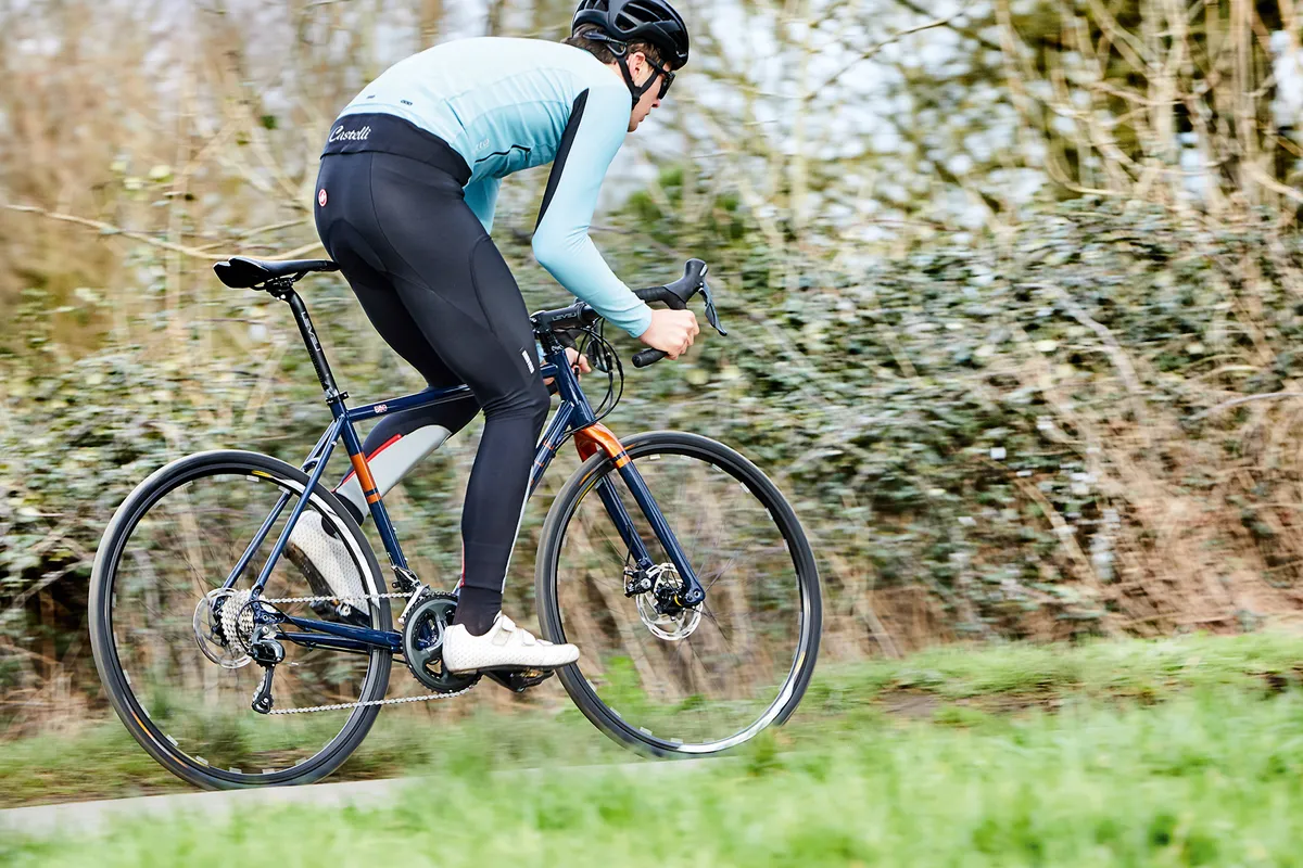 male cyclist riding blur gravel road bike
