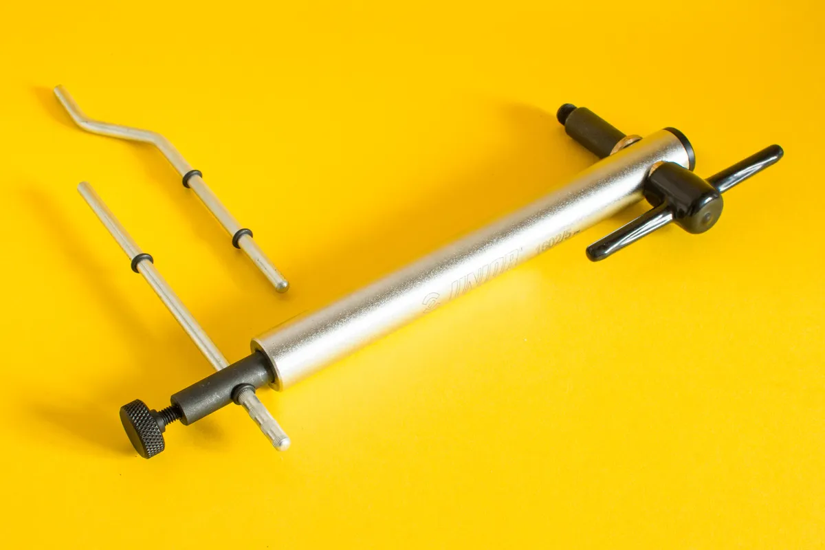 Derailleur hanger alignment tool on yellow background