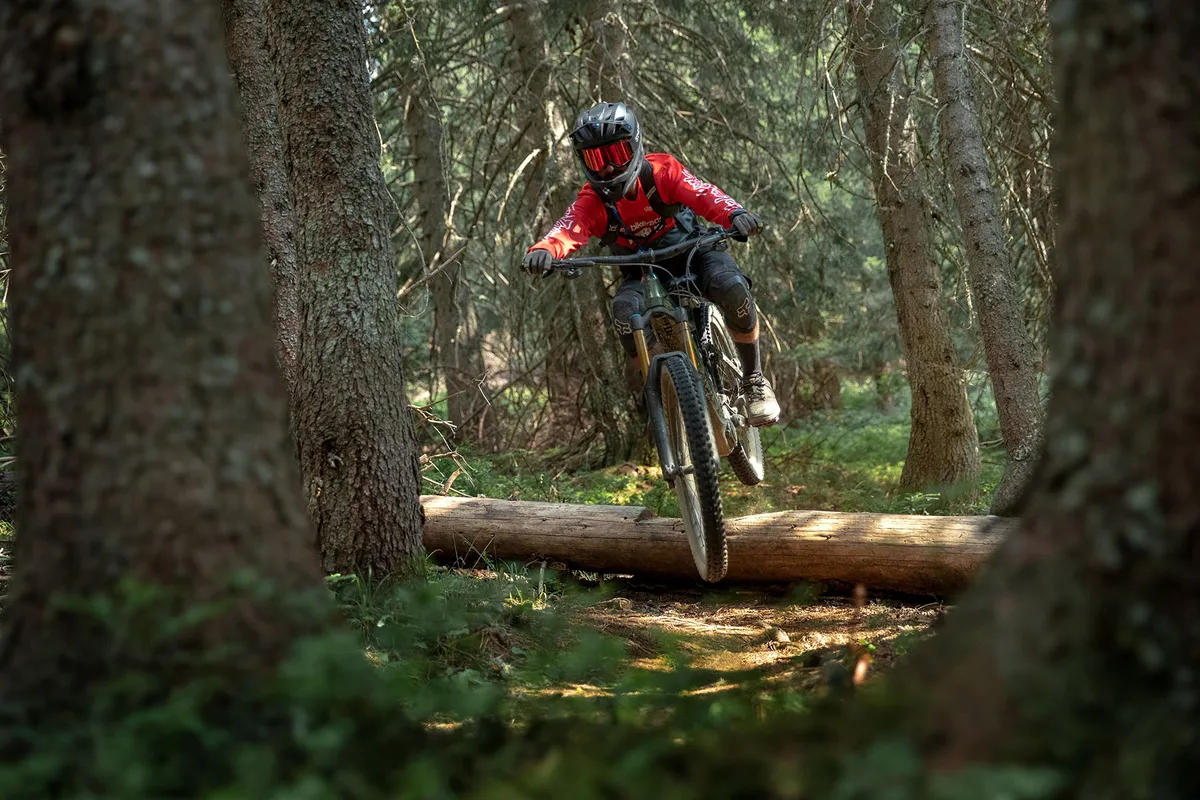 Cyclist in red top riding Giant Reign E  0 PRO