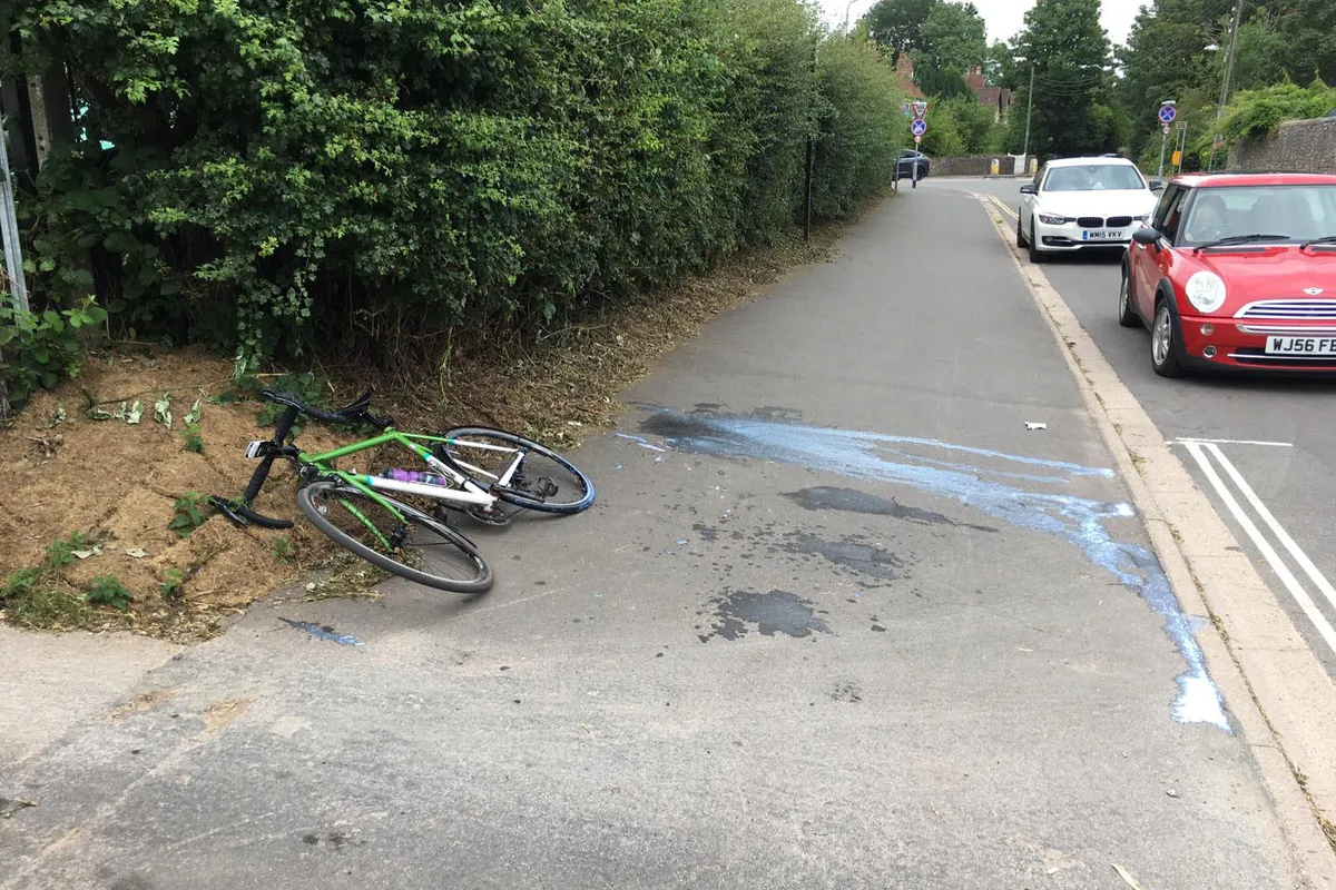 Bike lying on ground next to explosion of sealant from tubeless tyre
