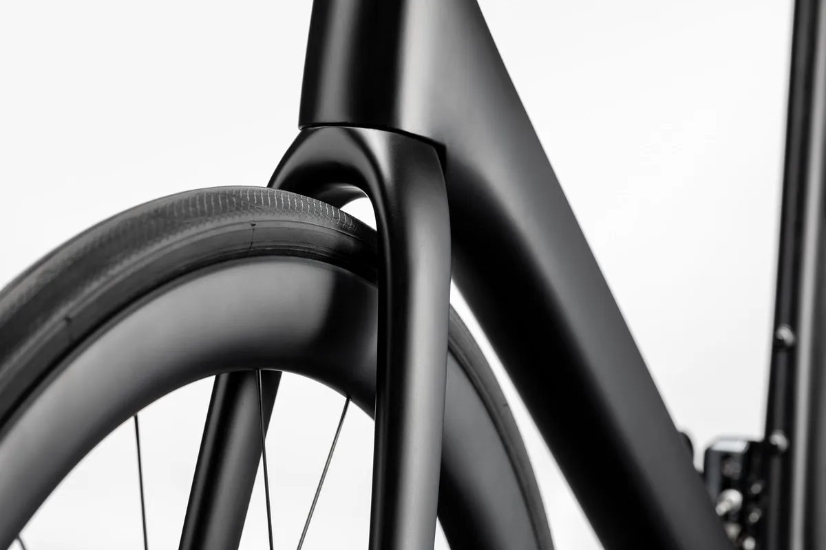 Fork and front wheel area of Cannondale SuperSix NEO e-bike showing large tyre clearance.