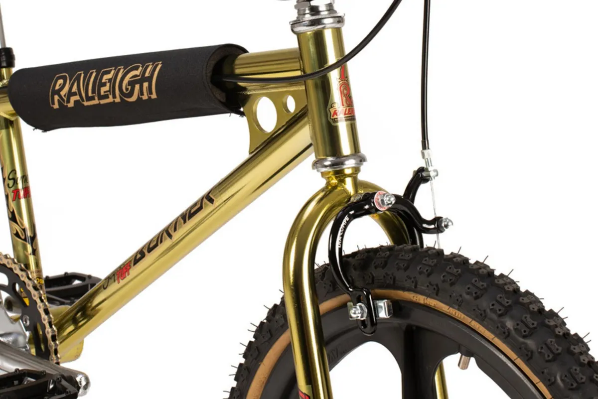 Front brake and head tube of gold BMX