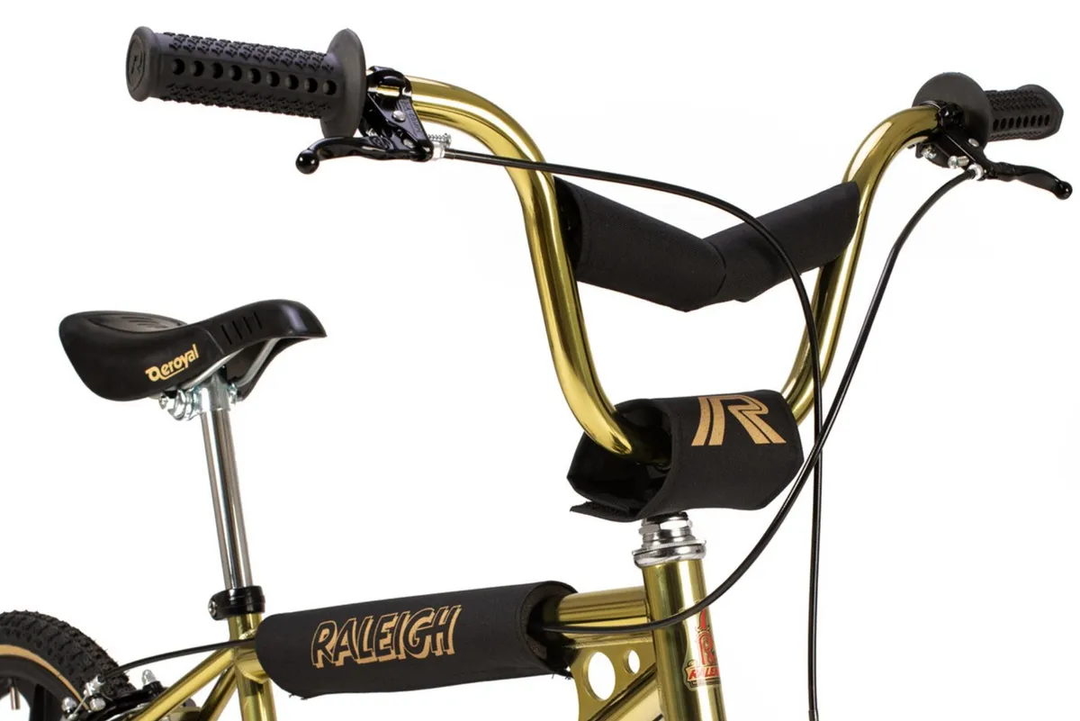 Handlebars of gold BMX bike.