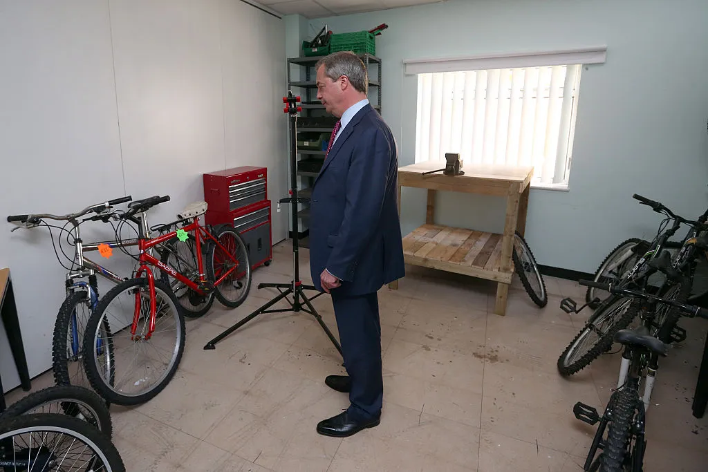SANDWICH, ENGLAND - APRIL 15: Ukip leader Nigel Farage looks at bicycles that are repaired by veterans during a visit to 'Veterans At Future For Heroes UK' on April 15, 2015 in Sandwich, England. Farage is continuing to campaign ahead of the forthcoming general election. (Photo by Carl Court/Getty Images)