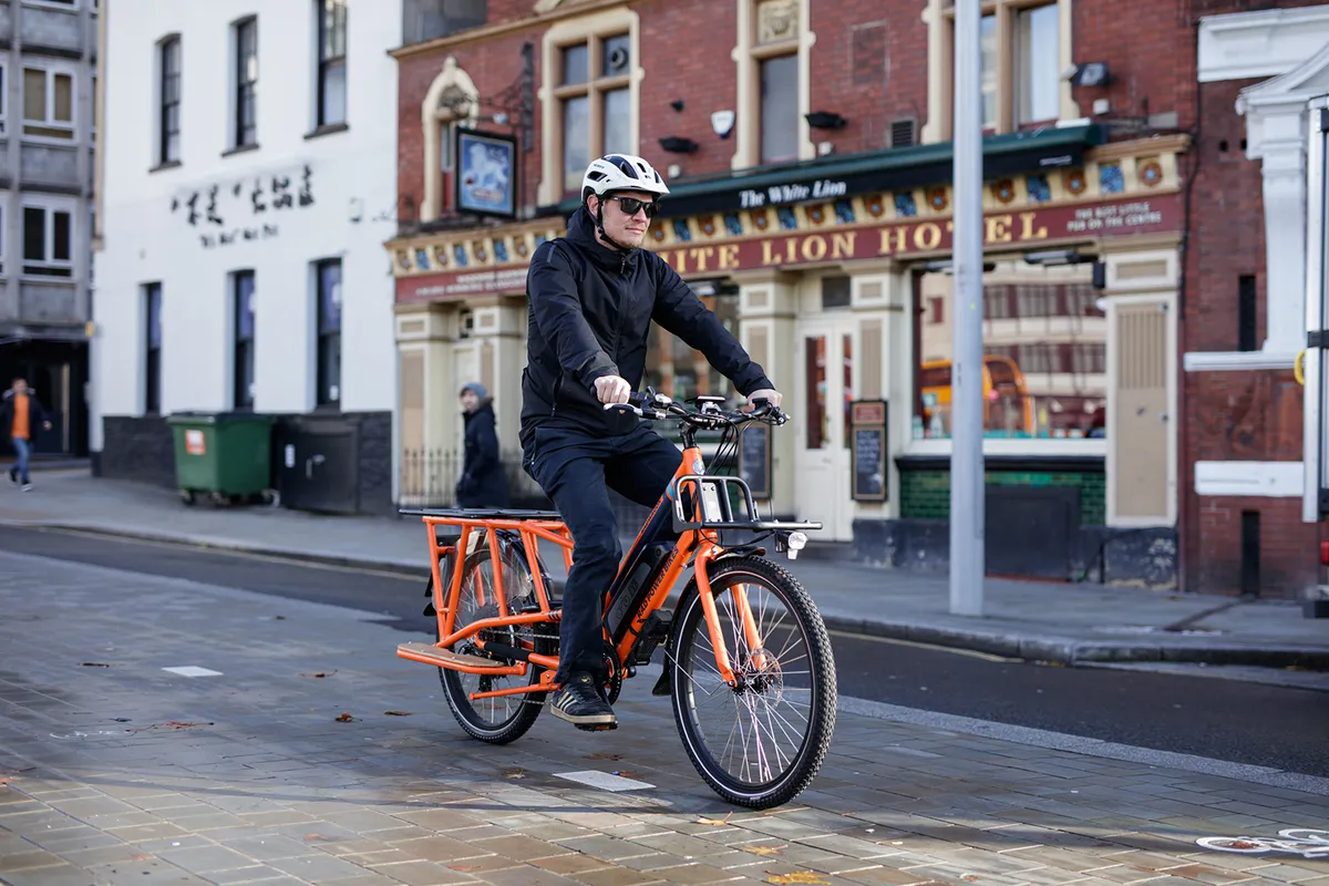 Cyclist riding the Rad Power RadWagon electric cargo bike