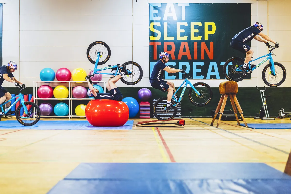 Danny MacAskill rolling over exercise ball in Gymnasium video