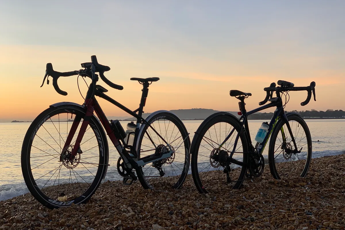A Marin Gestalt X Custom build road bike next to a Cannondale Synapse on Weymouth beach at sunrise