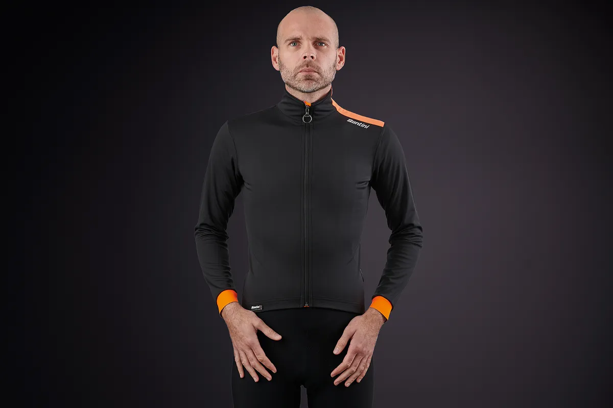 Waterproof road cycling jacket in black with orange trim from Santini