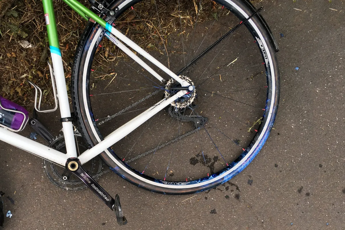 Tubeless sealant leaking from road bicycle tyre on pavement