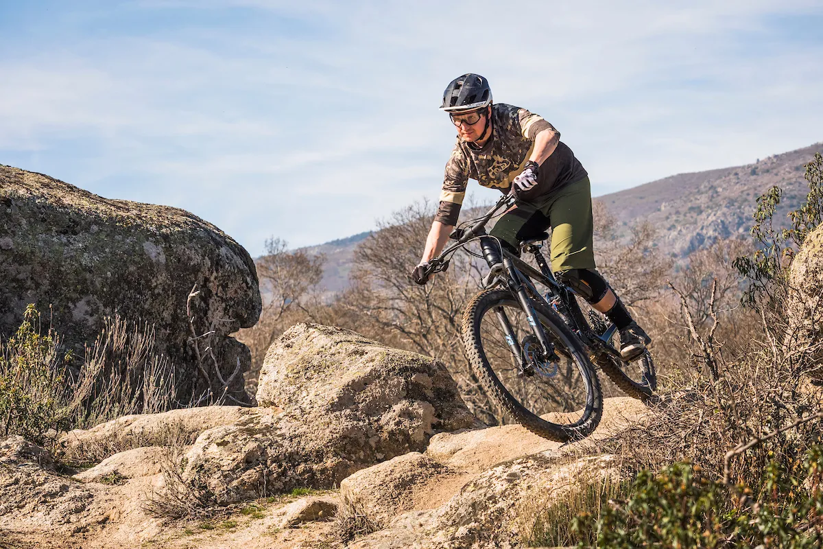 Cyclist in camouflage top riding a Bergamont Contrail Pro full suspension mountain bike