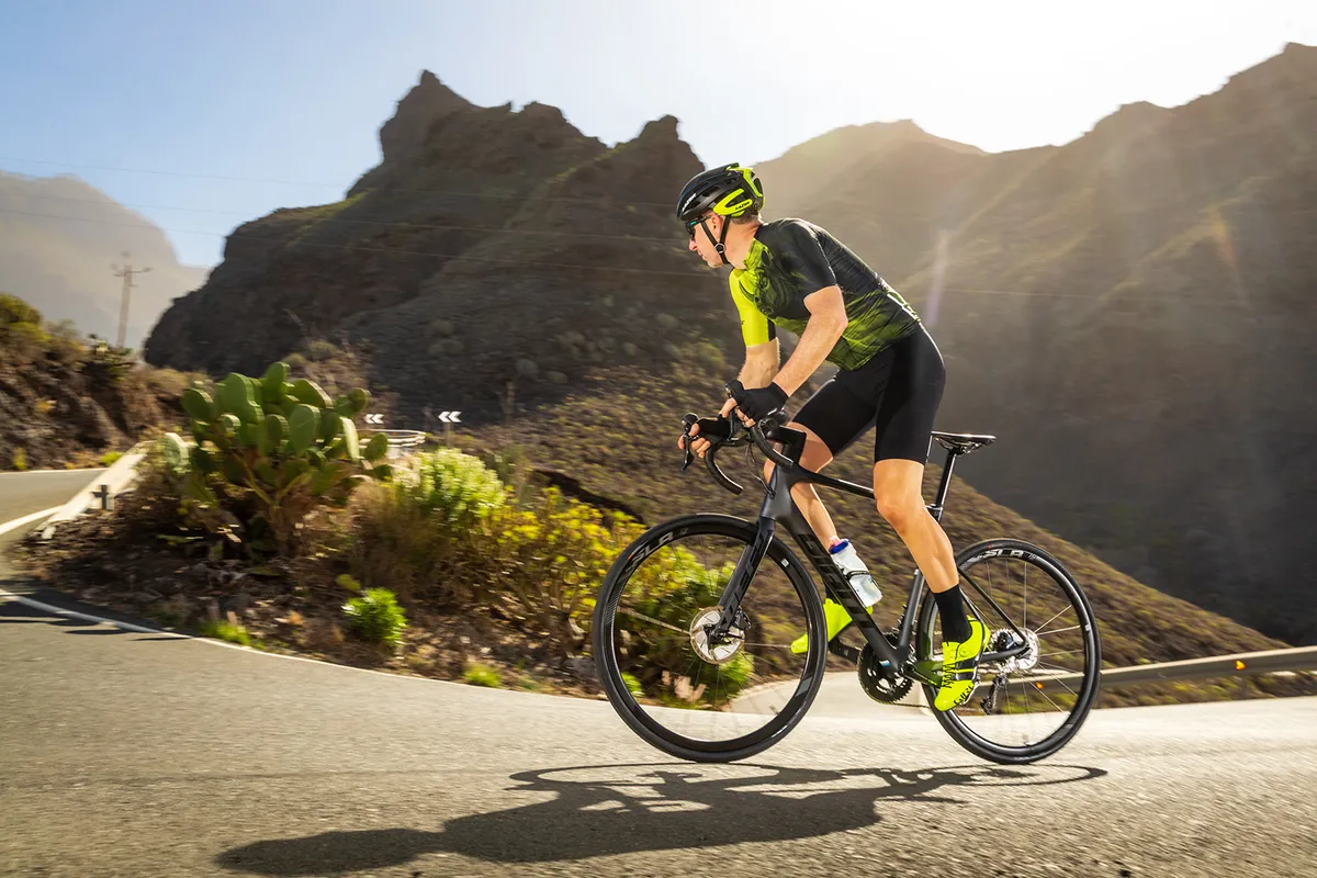 Male cyclist riding Giant Defy Advanced Pro 2 through Spanish mountains