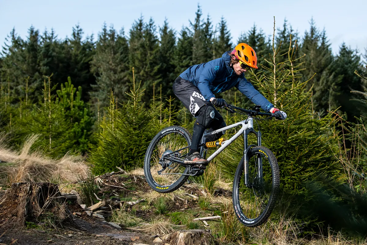 Male cyclist in blue riding the Starling Twist full suspension mountain bike