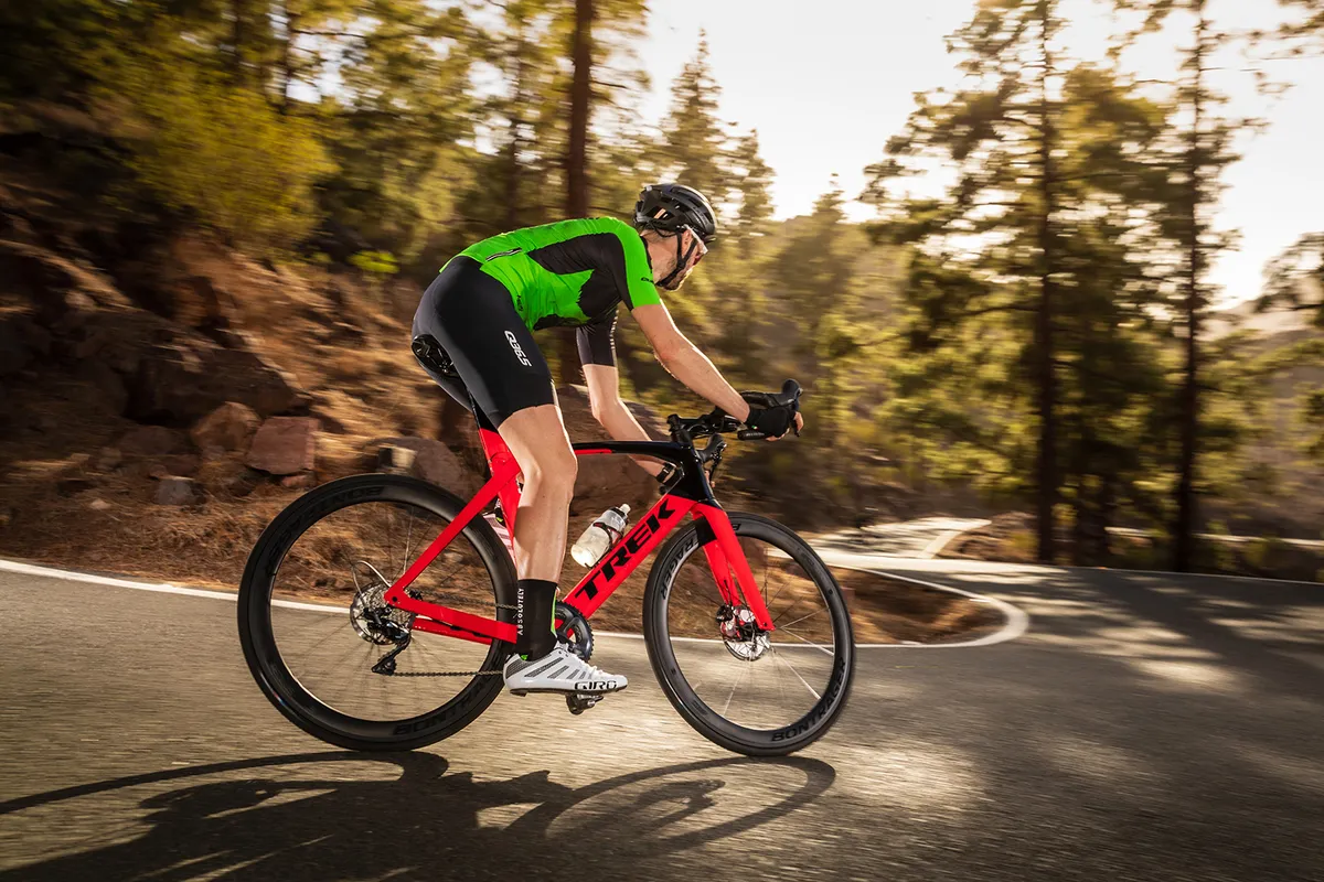 Cyclist in green top riding the Trek Madone SL6 Disc