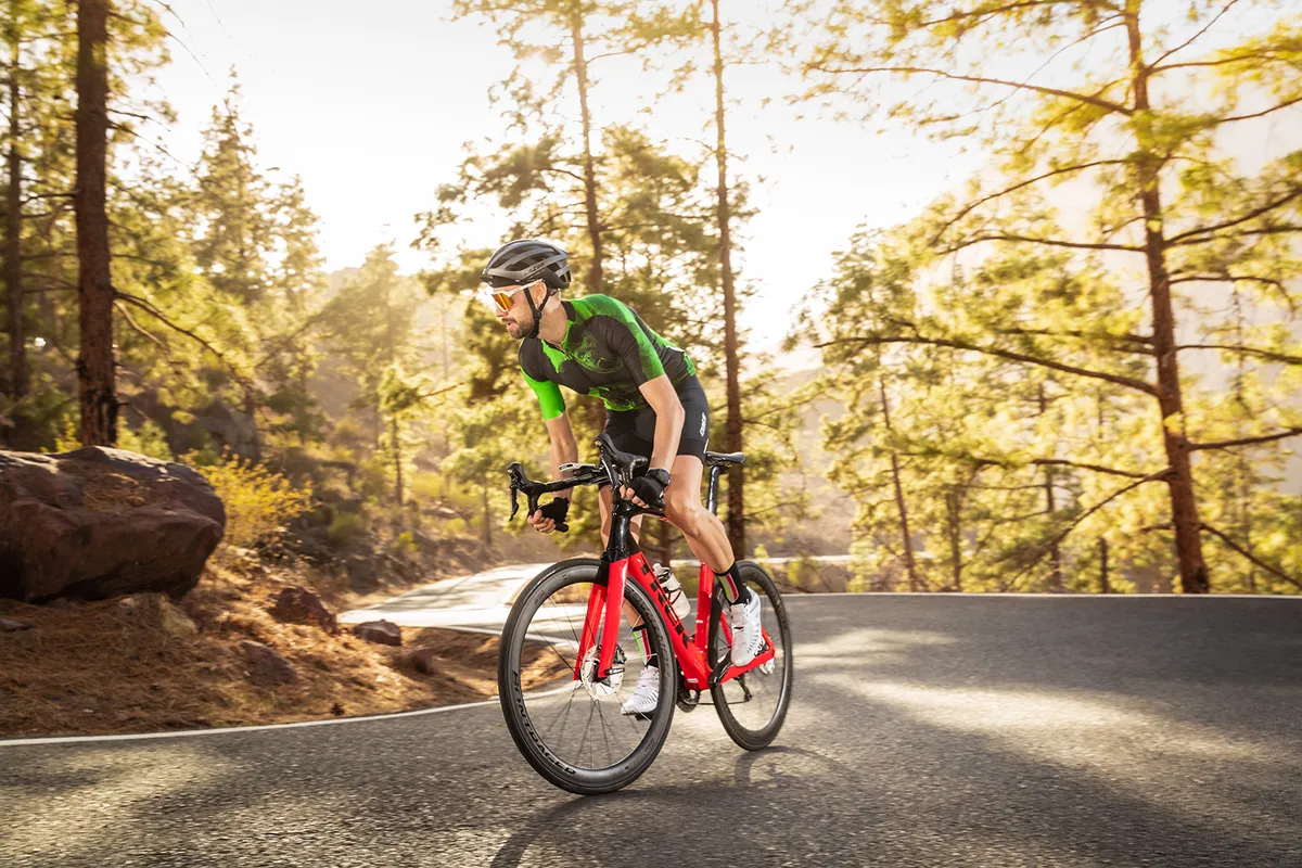 Cyclist in green top riding the Trek Madone SL6 Disc