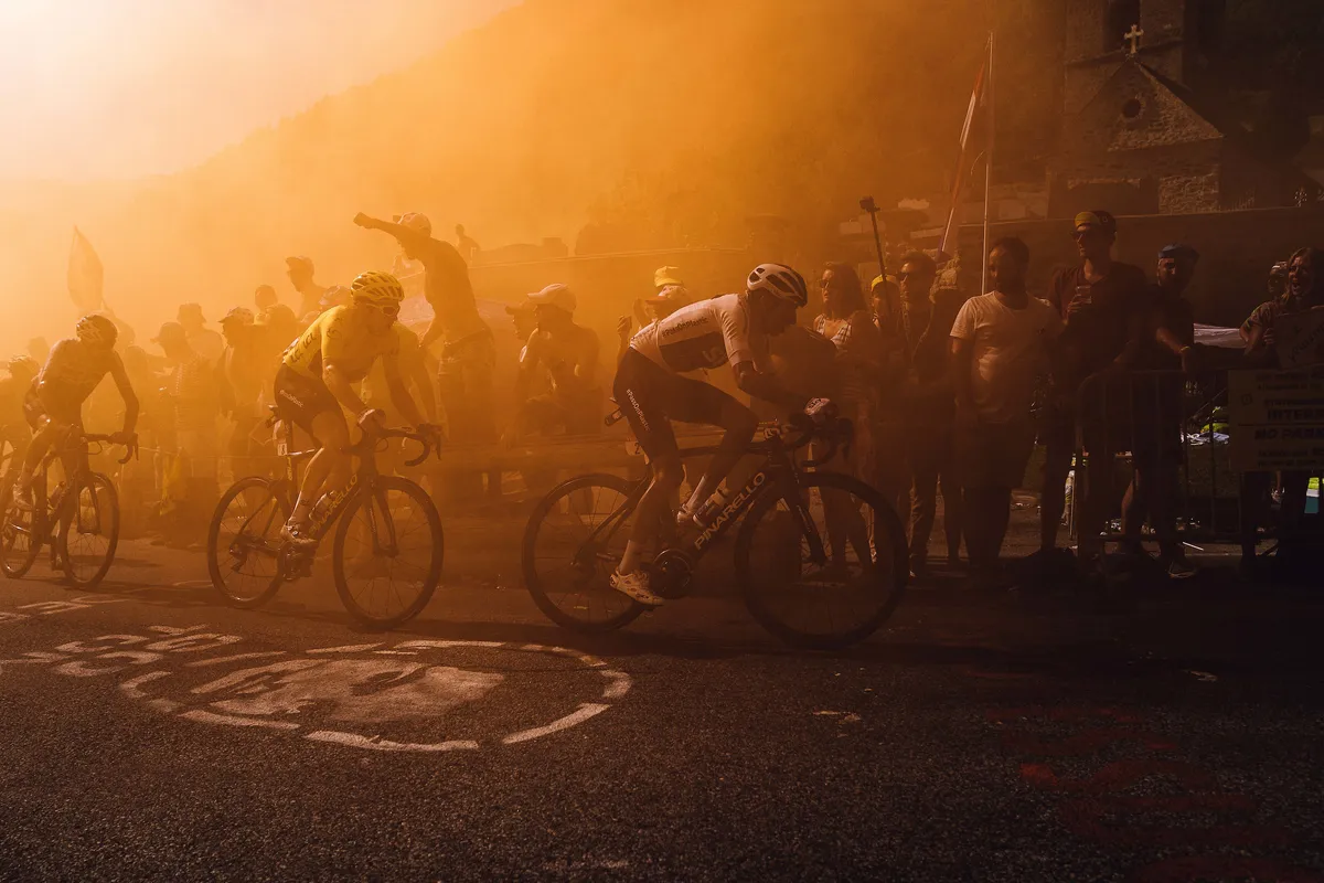 Geraint Thomas riding through smoke at the 2018 Tour de France