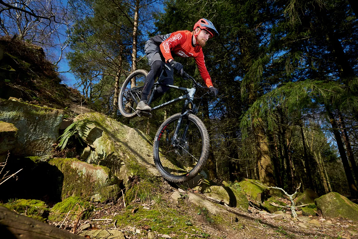 Cyclist riding the Vitus Sentier 29 hardtail mountain bike over rocky terrain
