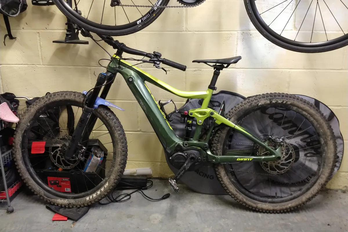 e-MTB with bars turned resting against wall