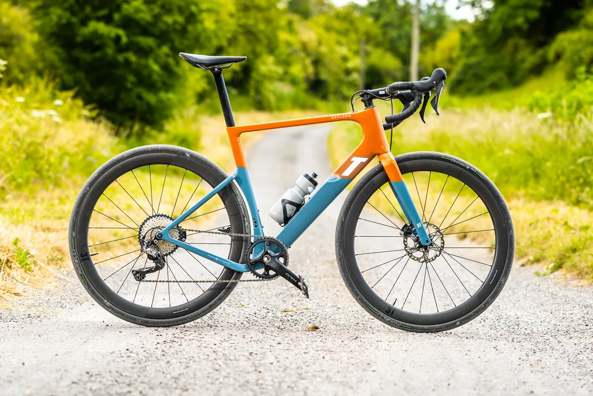 Pack shot of the 3T Exploro RaceMax gravel bike in orange and blue