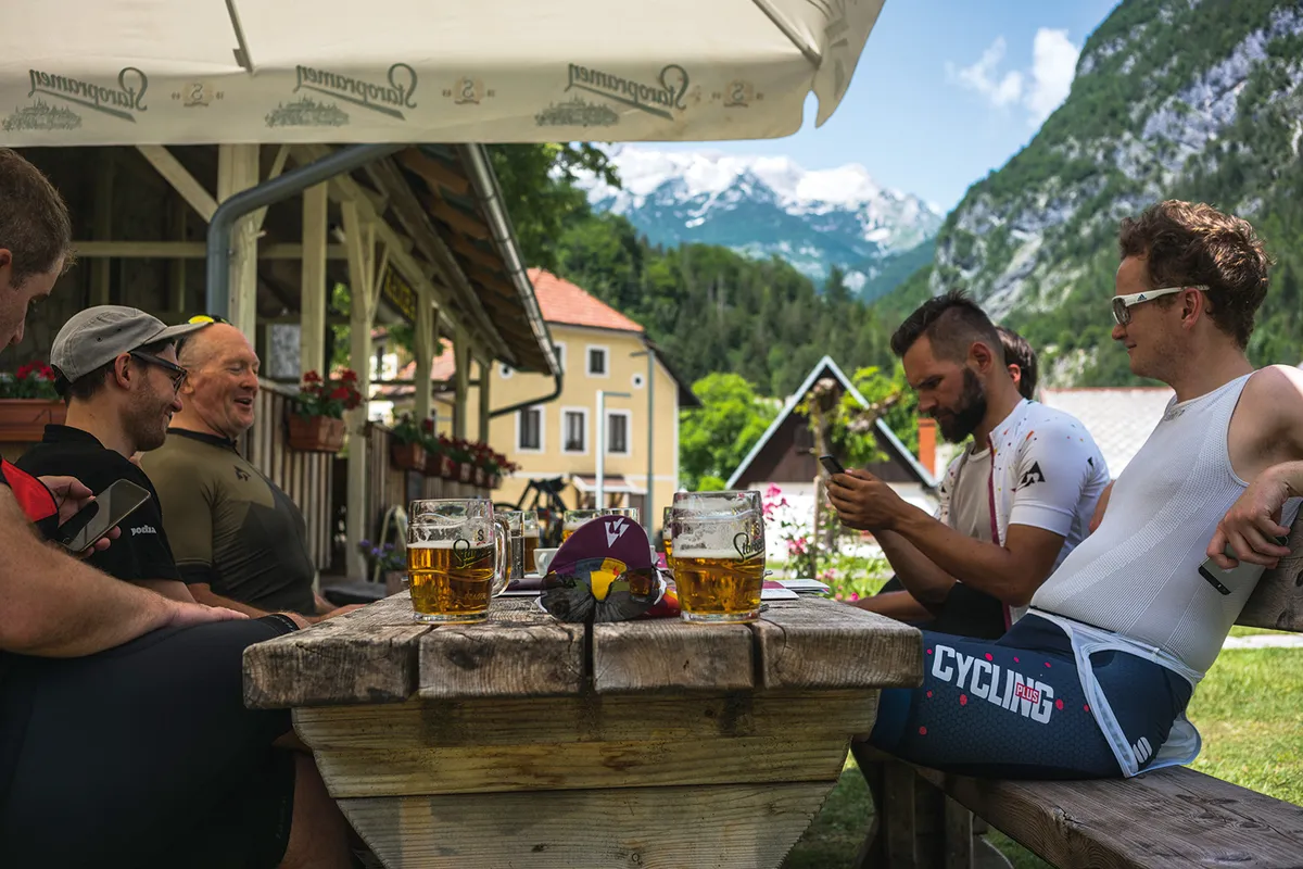 Cyclists take time out for a beer during their ride through the Julian Alps of Slovenia