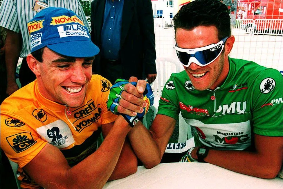 EVREUX, FRANCE - JULY 10: Belgian Wilfried Nelissen (L) and Italian Mario Cipollini arm wrestle in Evreaux, France, 09 July 1993 before the start of the sixth stage of the Tour de France. Cipollini finished second regaining the overall lead from Nelissen. (Photo credit should read VINCENT AMALVY/AFP via Getty Images)