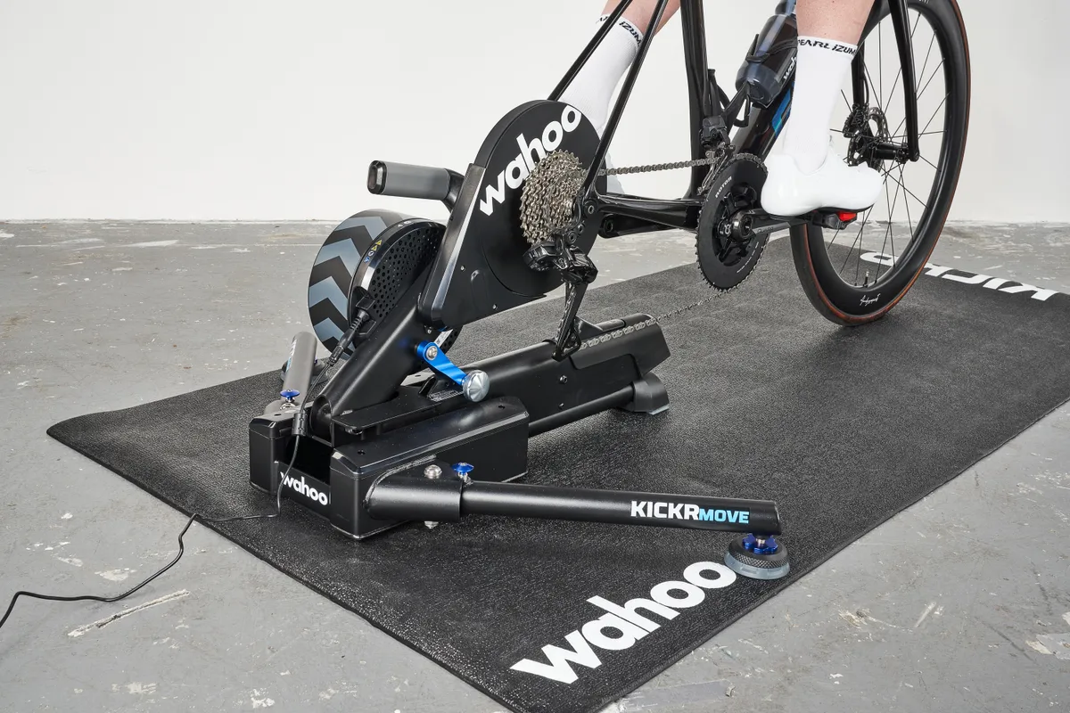 Indoor cycling setup with a Wahoo Kickr Move smart trainer on a training mat