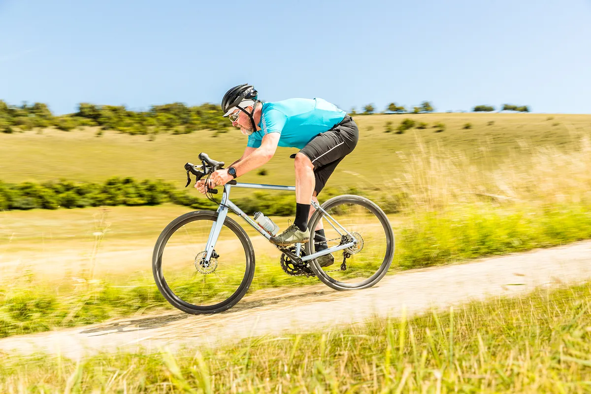 Cyclist in light blue top riding the Marin Nicasio 2 gravel bike