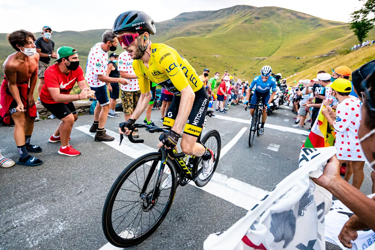 Adam Yates climbing in the yellow jersey at the Tour de France 2020