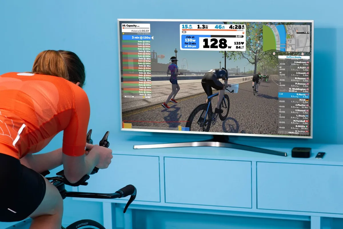 Female cyclist using Zwift on a television