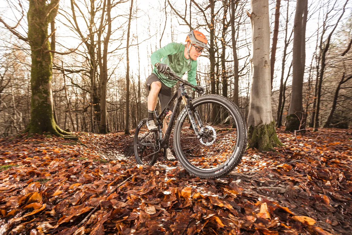 Cyclist in green top riding the Merida Ninety-Six RC 9000 full-suspension mountain bike