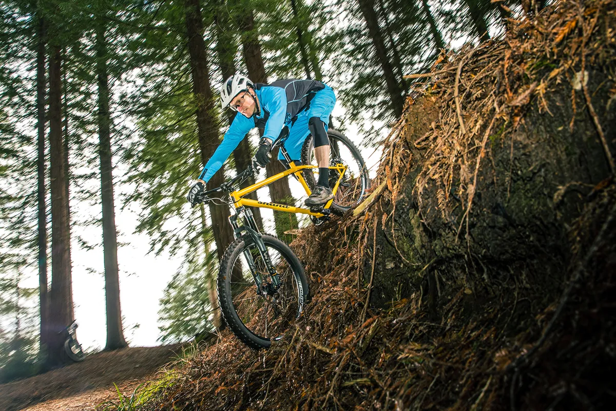 Cyclist in blue top riding the steel framed hardtail Shand Shug mountain bike
