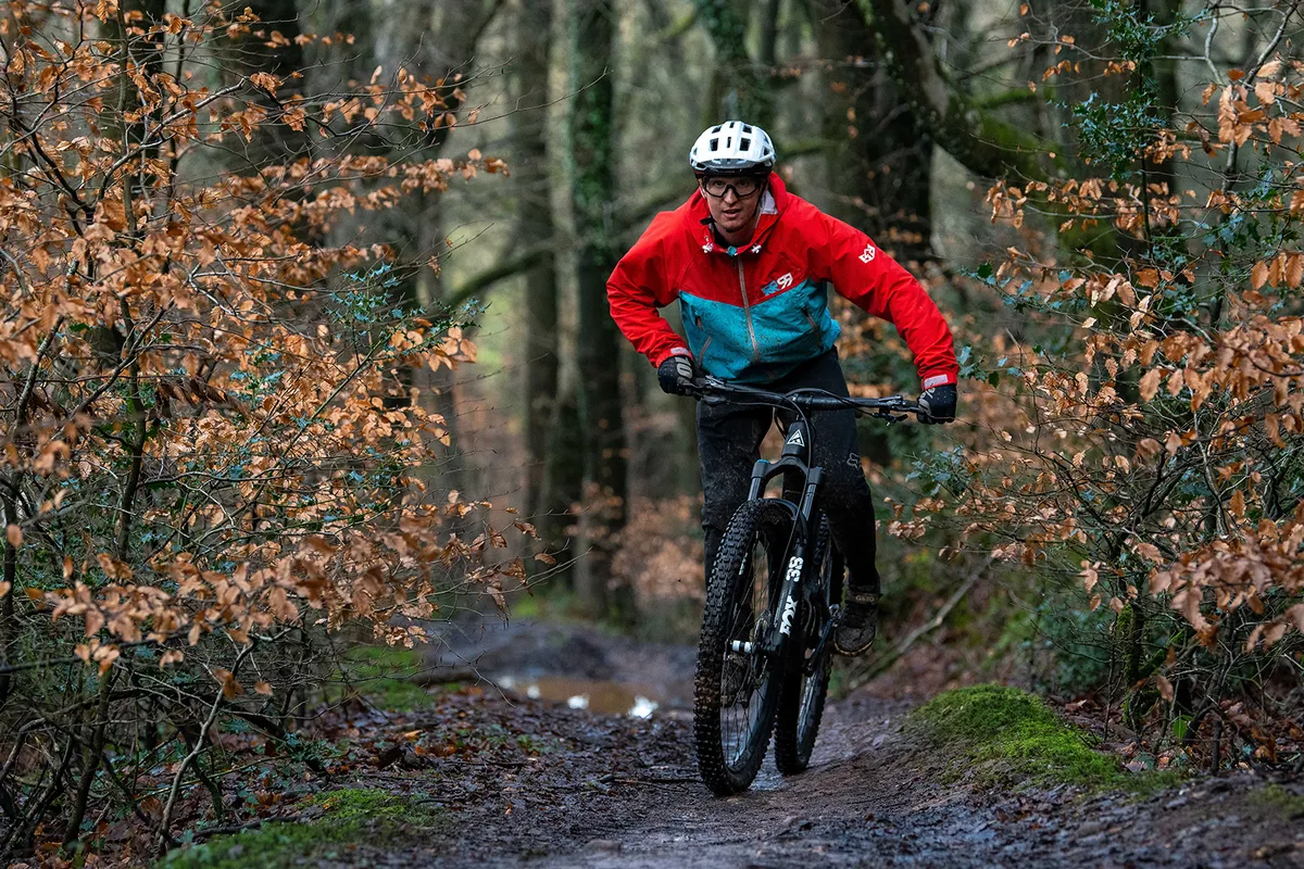 Cyclist in red and blue top riding the Forbidden Dreadnought XT full-suspension mountain bike