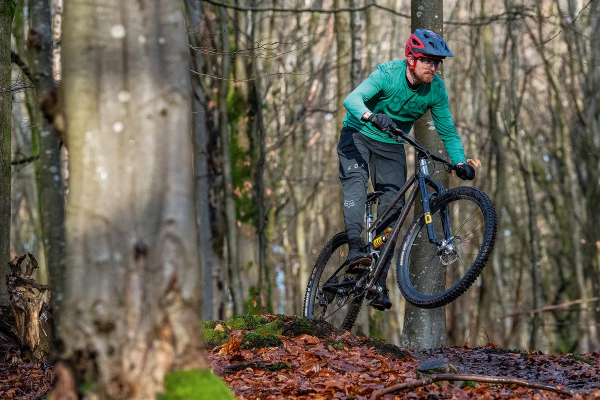 Cyclist in green top riding the Starling Murmur full-suspension mountain bike